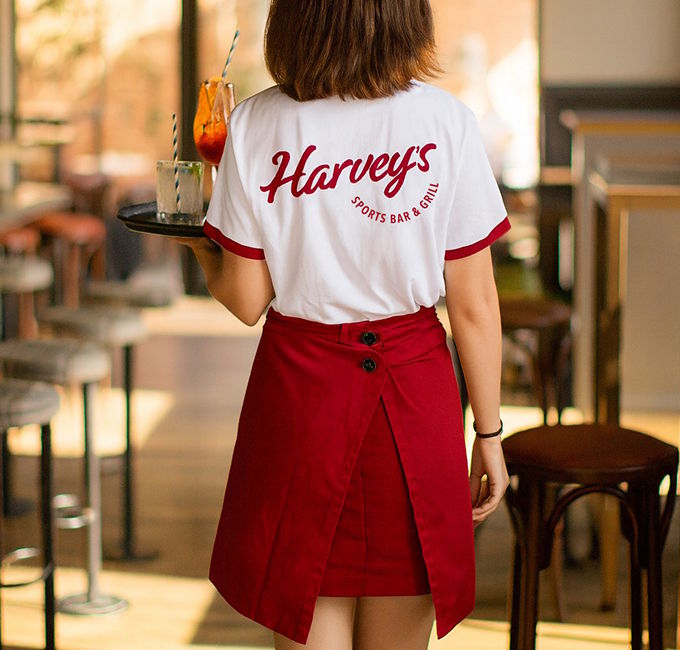 clothing, skirt, person, cup, accessories, bracelet, jewelry, furniture, table, miniskirt